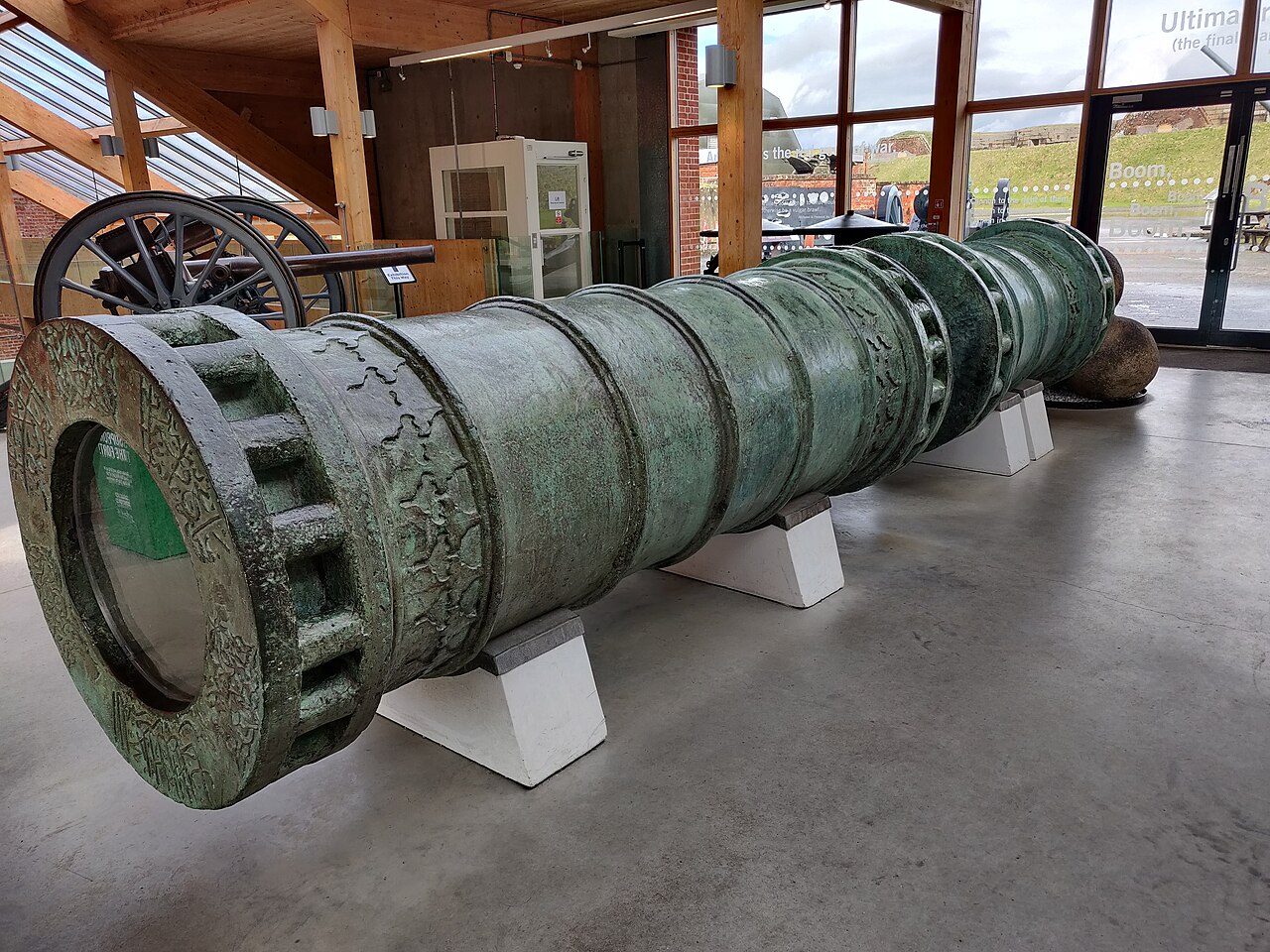 A huge bronze bombard in two screw-together sections, displayed on supports